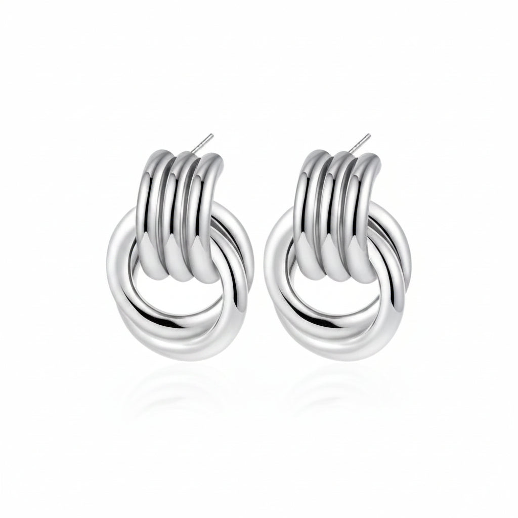 Pair of silver knot earrings with measurements on a white background